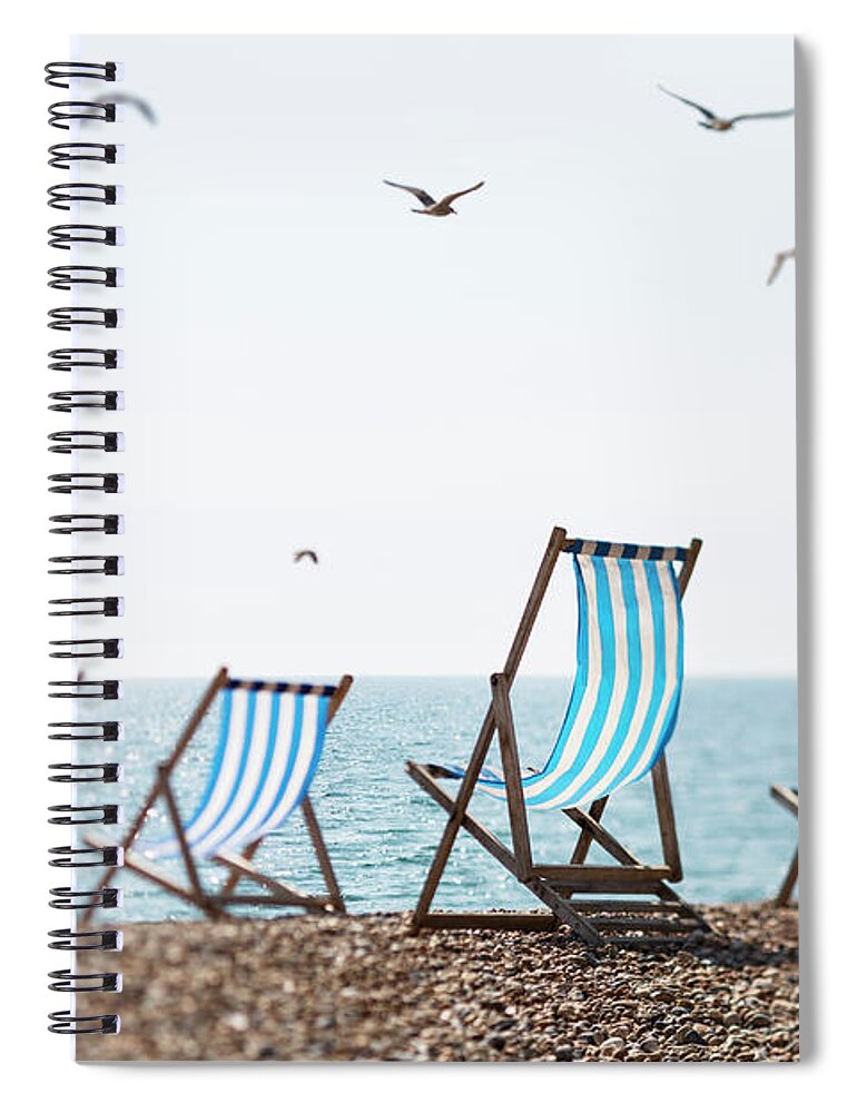 Tranquility Spiral Notebook featuring the photograph Four Deckchairs On A Beach And Seagulls by Richard Boll