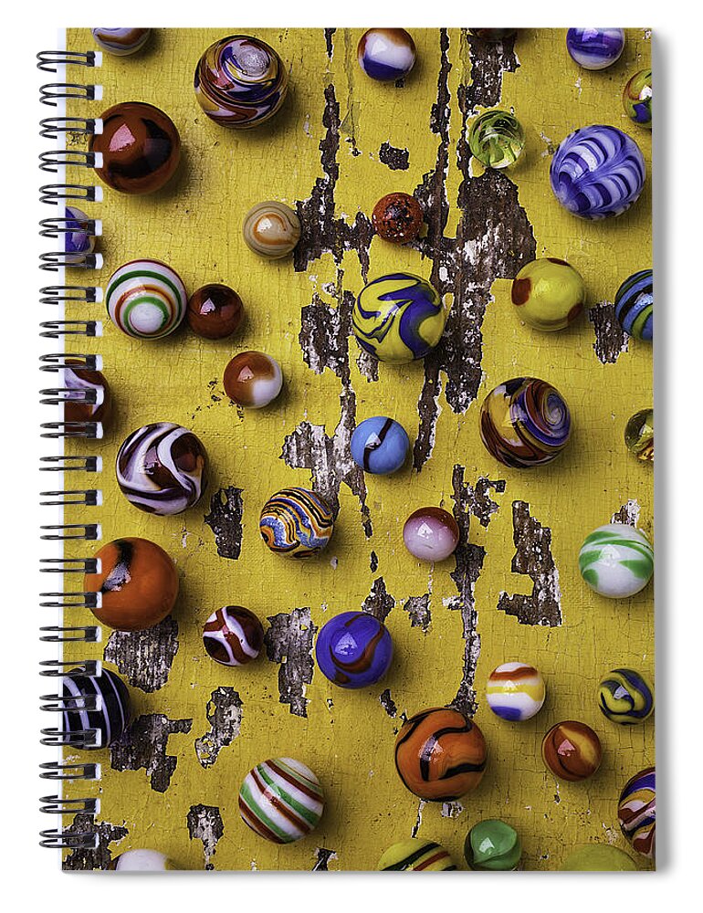 Marbles Spiral Notebook featuring the photograph Marbles On Yellow Wooden Table by Garry Gay