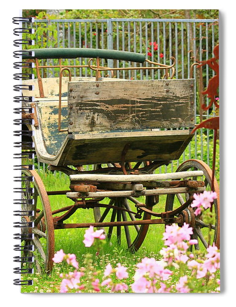 Aged Spiral Notebook featuring the photograph Vintage horse carriage in a flower bed by Amanda Mohler
