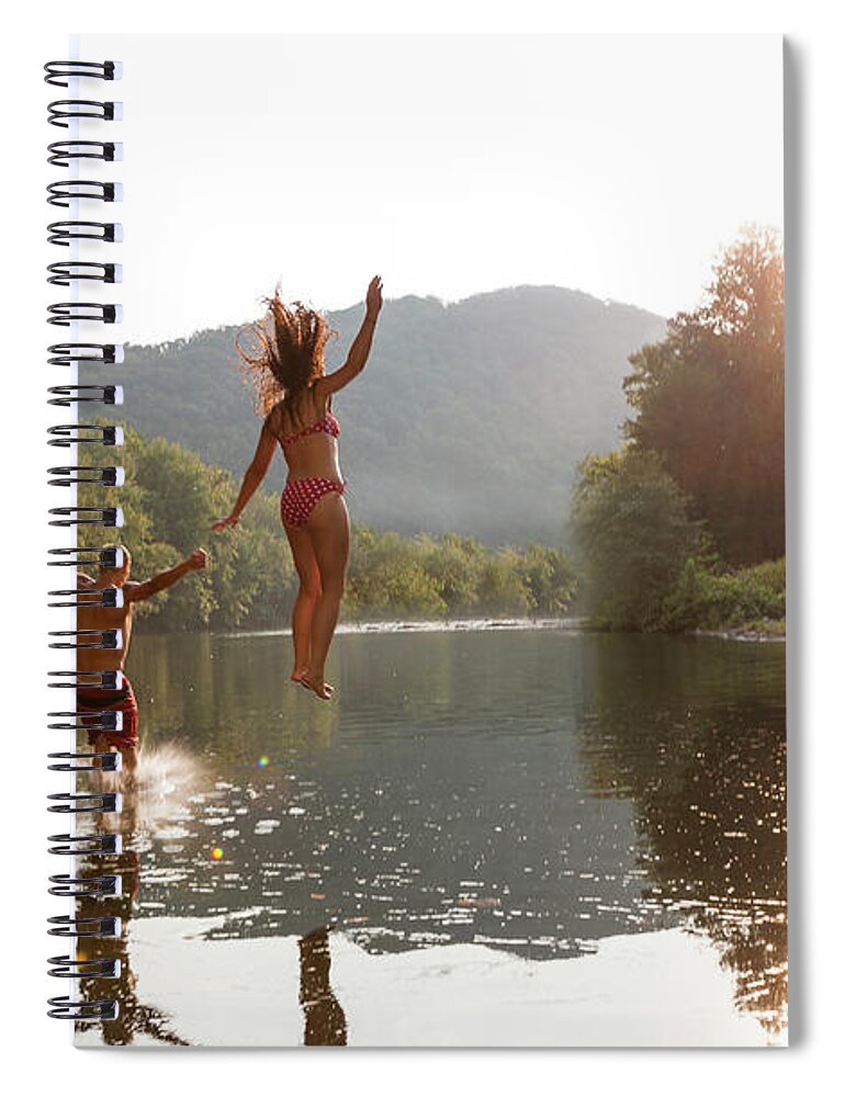 Young Men Spiral Notebook featuring the photograph Young Couple Jumping Into River by Zave Smith