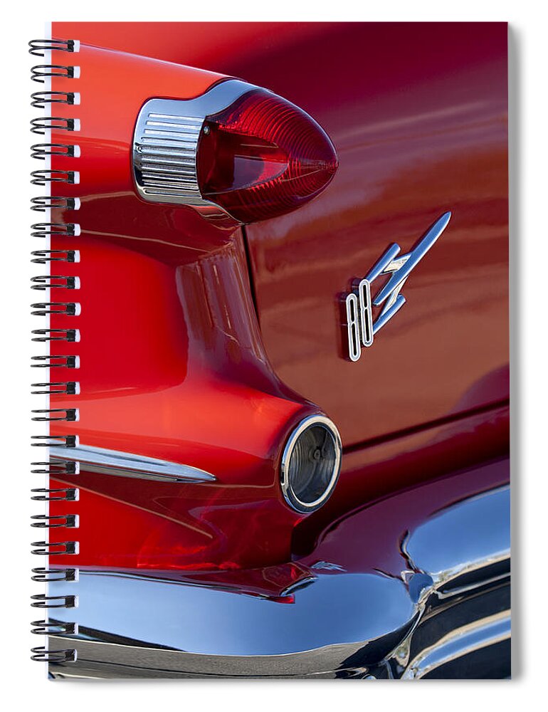 1956 Oldsmobile 88 Spiral Notebook featuring the photograph 1956 Oldsmobile 88 Taillight Emblem by Jill Reger