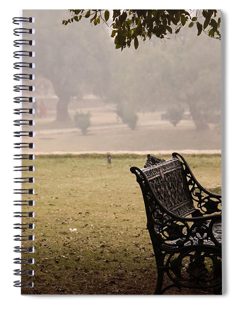 Bench Spiral Notebook featuring the photograph A wrought iron black metal bench under a tree in the Qutub Minar compound by Ashish Agarwal