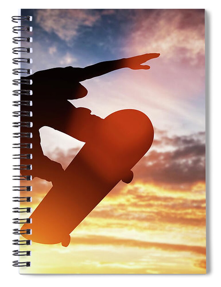 Man Spiral Notebook featuring the photograph Skateboarder jumping at sunset. #1 by Michal Bednarek
