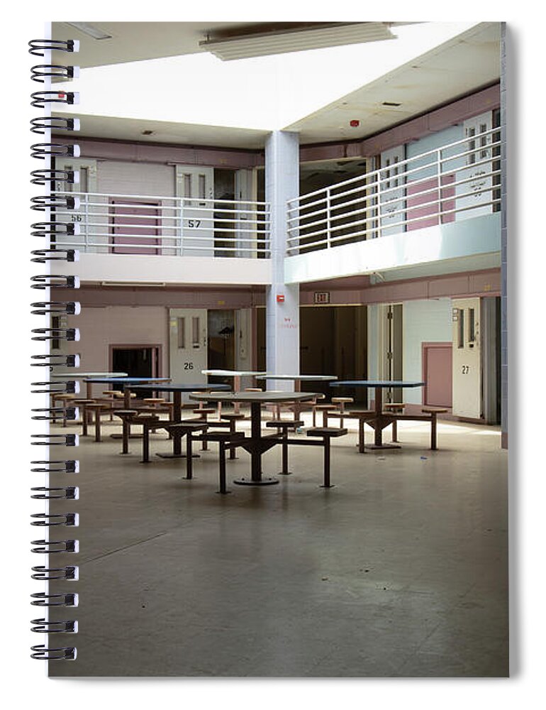 America Spiral Notebook featuring the photograph Abandoned jail common room in cell block by Karen Foley