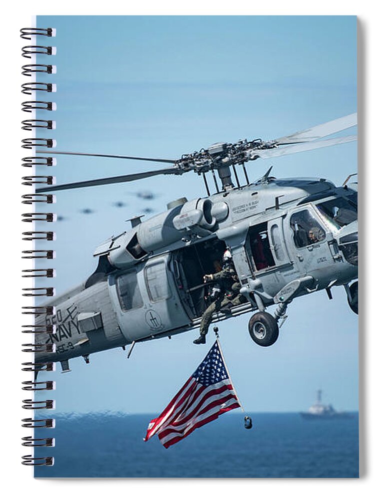 Military Spiral Notebook featuring the painting An MH-60S Sea Hawk helicopter displays the American flag. by Celestial Images