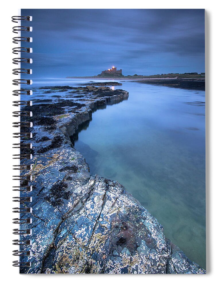 Bamburgh Castle Spiral Notebook featuring the photograph Bamburgh Castle blue hour from the rocks after dark by Anita Nicholson