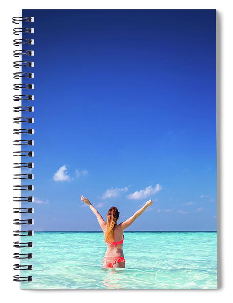 Woman Spiral Notebook featuring the photograph Beautiful young woman standing in the ocean with hands raised. Maldives by Michal Bednarek