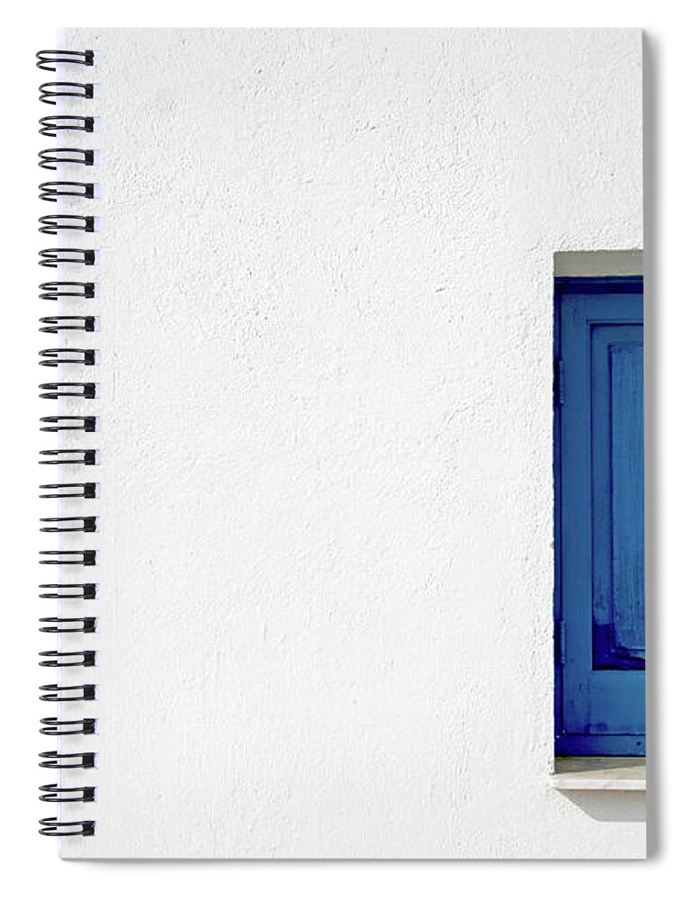 Architecture Spiral Notebook featuring the photograph Blue window on a white wall by Michalakis Ppalis