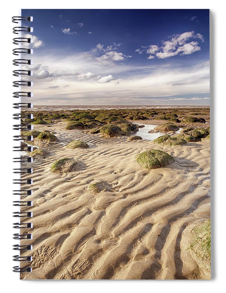 Sand Spiral Notebook featuring the photograph Golden sand lines and seaweed rocks of Norfolk by Simon Bratt