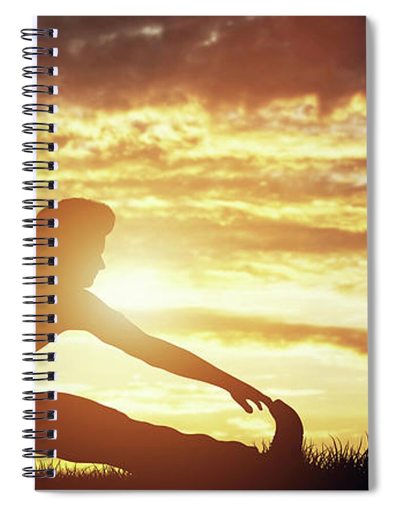 Man Spiral Notebook featuring the photograph Man stretching his body in the sunset. by Michal Bednarek