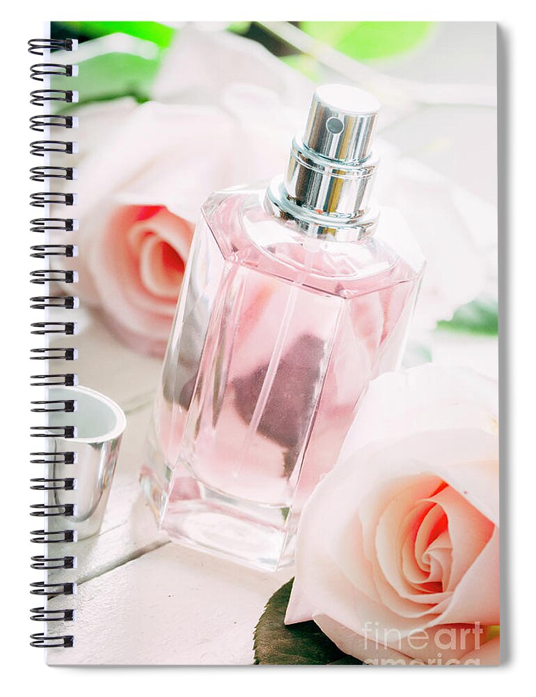 Perfume Spiral Notebook featuring the photograph Perfume bottle and pink roses. by Jelena Jovanovic