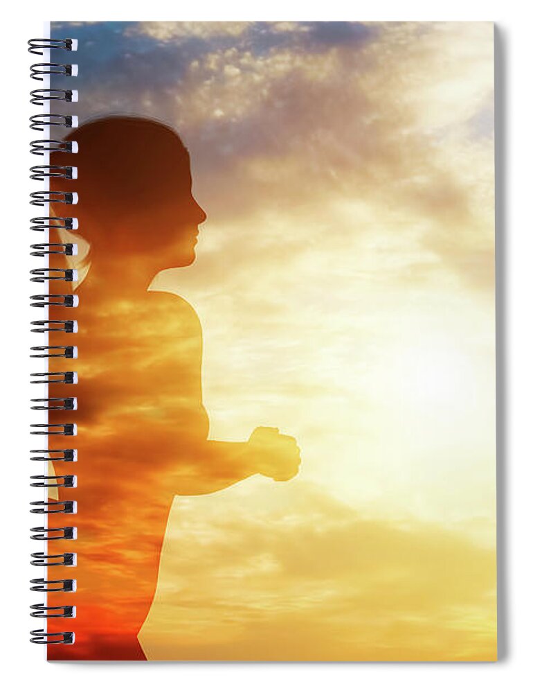 Woman Spiral Notebook featuring the photograph Silhouette of a running woman on sky background. by Michal Bednarek