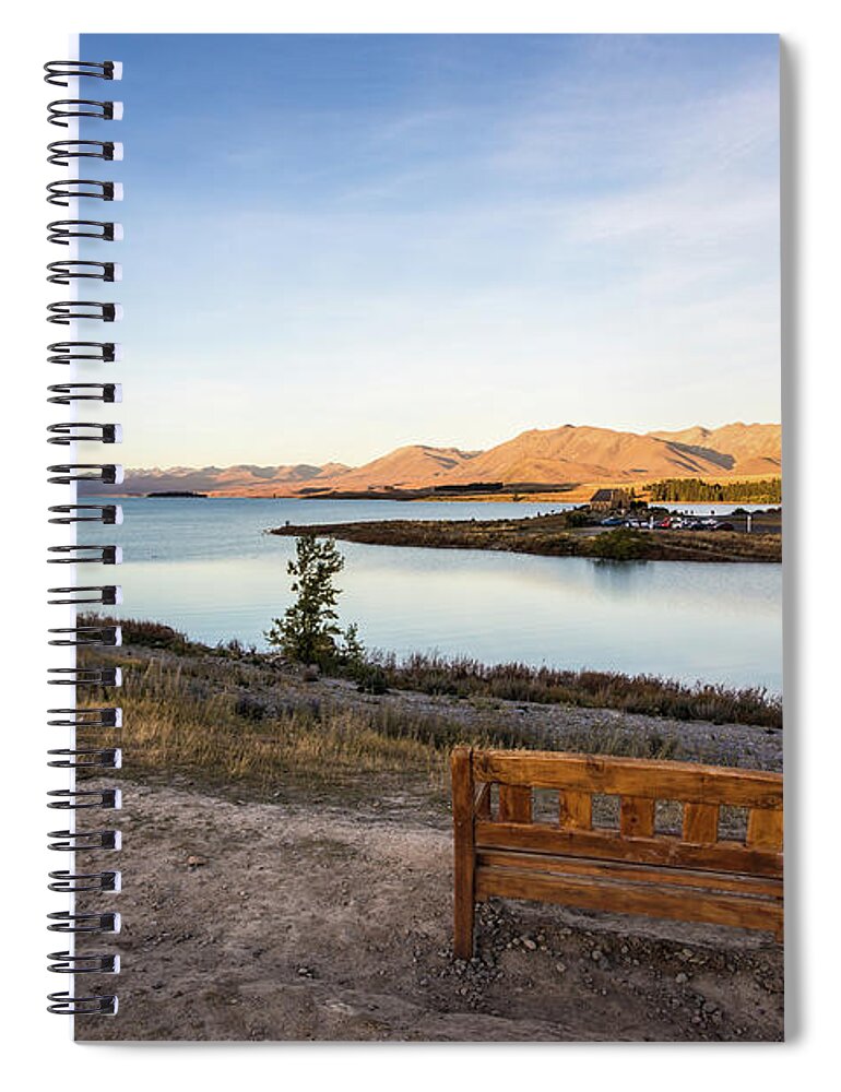 New Zealand Spiral Notebook featuring the photograph Sunset over a bench overlooking the stunning Lake Tekapo in New by Didier Marti