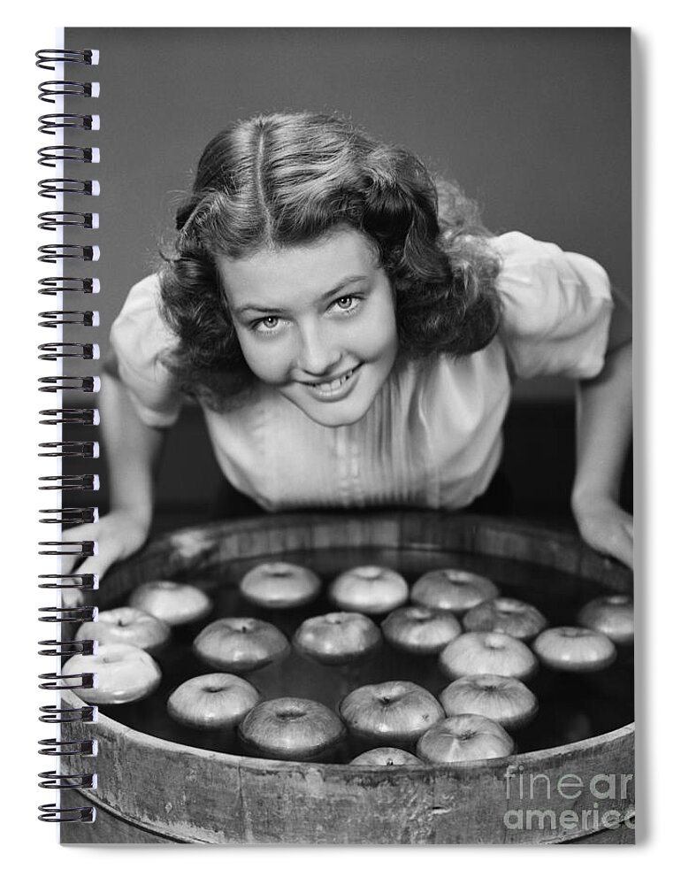 1940s Spiral Notebook featuring the photograph Teen Girl Bobbing For Apples, C.1940s by H. Armstrong Roberts/ClassicStock