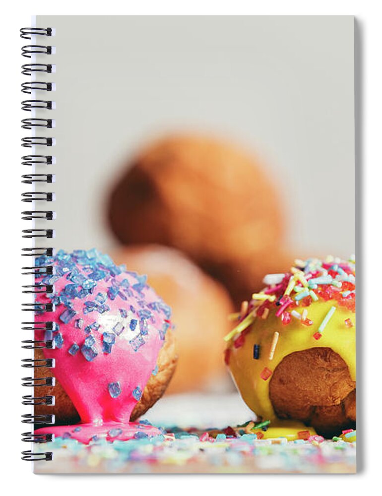Food Spiral Notebook featuring the photograph Two decorated doughnuts laying on a table. by Michal Bednarek
