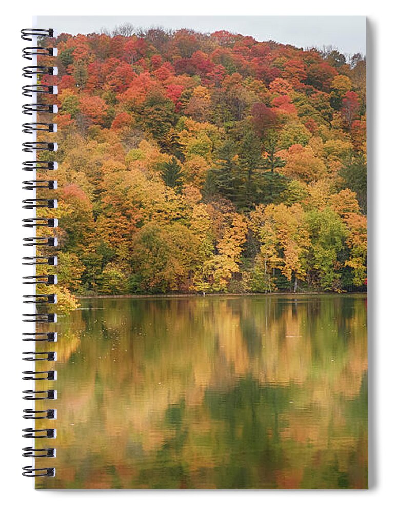 Abenaki Spiral Notebook featuring the photograph Vermont fall foliage reflected on Pogue Pond by Jeff Folger