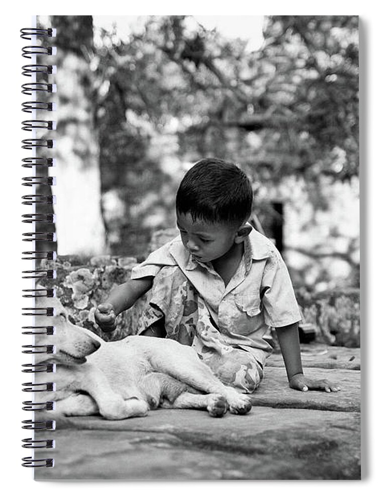 2015 Spiral Notebook featuring the photograph Cambodian boy near some ruins playing with his dog. #1 by Joaquin Corbalan