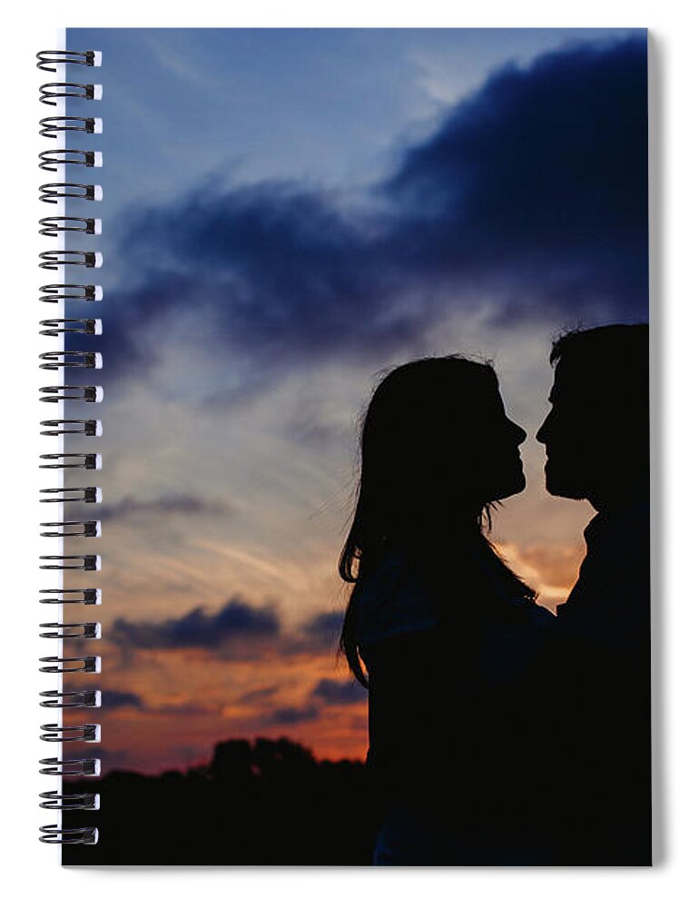 Background Spiral Notebook featuring the photograph Couple with cloud sky backlight #1 by Joaquin Corbalan