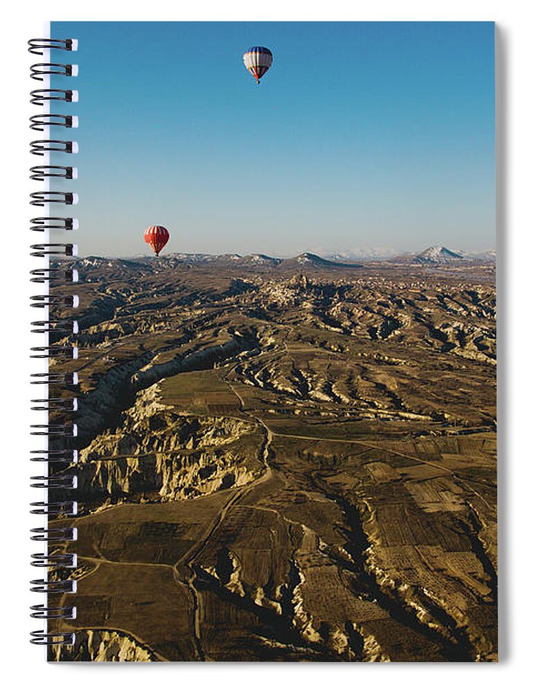 Adventure Spiral Notebook featuring the photograph Colorful balloons flying over mountains and with blue sky #6 by Joaquin Corbalan