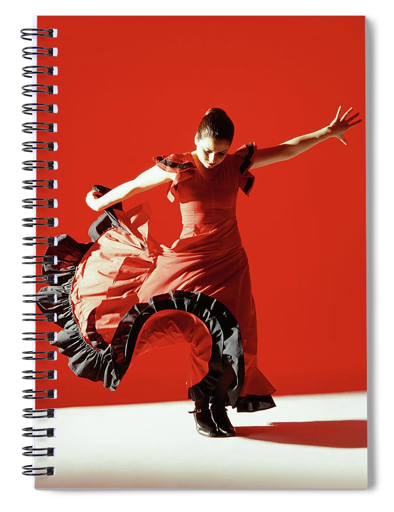 Ballet Dancer Spiral Notebook featuring the photograph A Female Flamenco Dancer Performing A by George Doyle