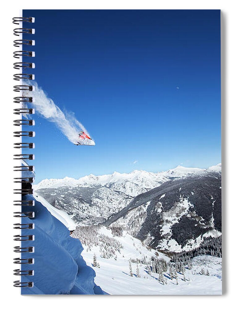 Scenics Spiral Notebook featuring the photograph A Snowboarder Jumps Off A Cliff Into by Patrick Orton