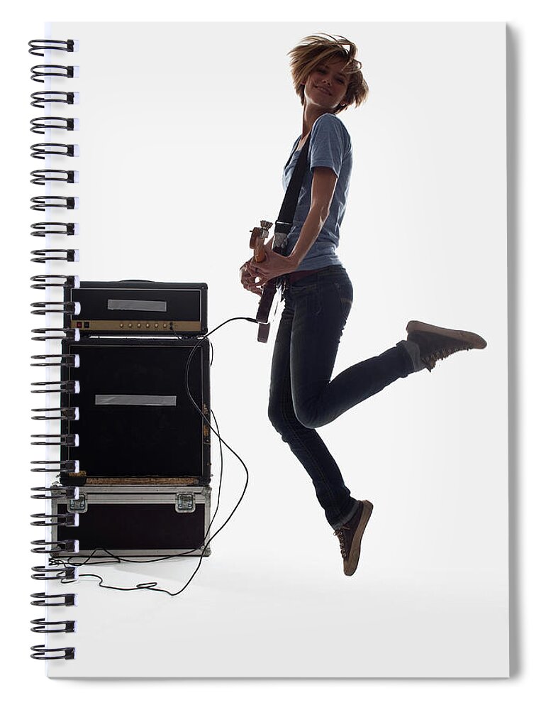 Cool Attitude Spiral Notebook featuring the photograph A Woman Jumping While Playing An by Antenna