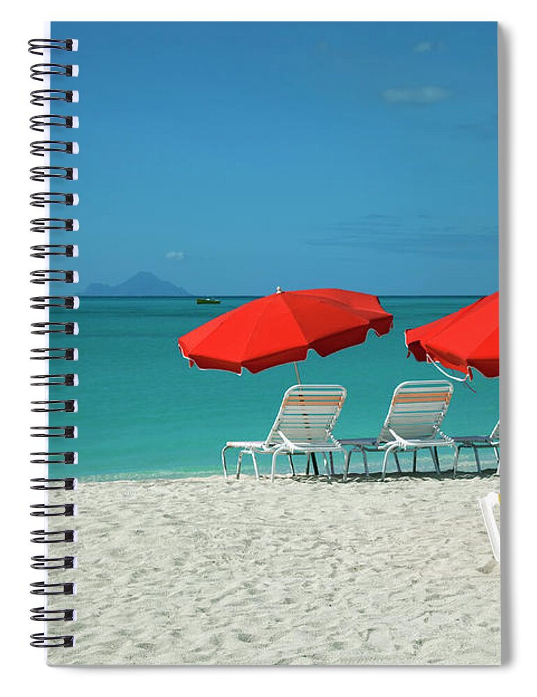 In A Row Spiral Notebook featuring the photograph Beach Sun Loungers And Sunshades by Onfilm