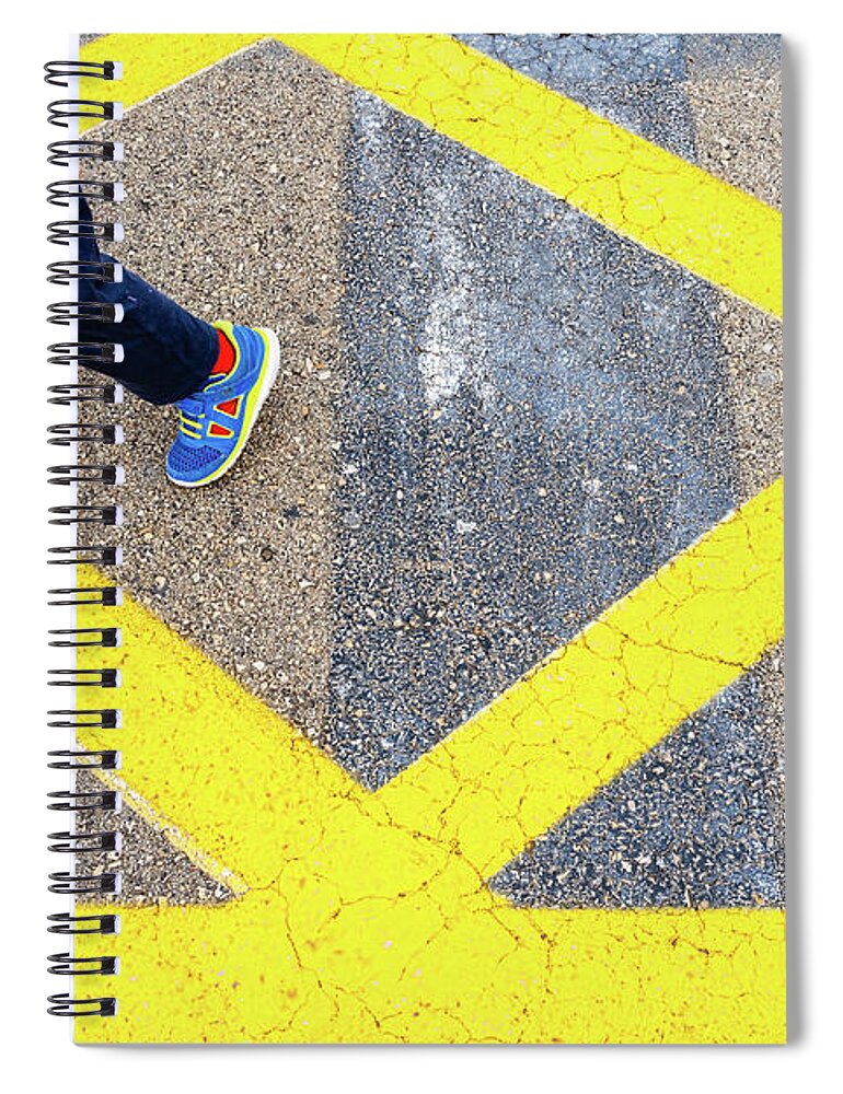 Asphalt Spiral Notebook featuring the photograph Child's legs on yellow lines on asphalt. by Joaquin Corbalan