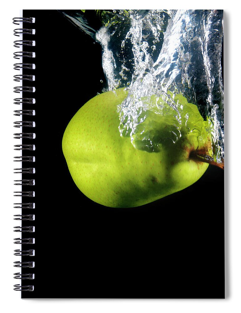 Black Background Spiral Notebook featuring the photograph Green Pear Sinking In Water by Henrik Sorensen