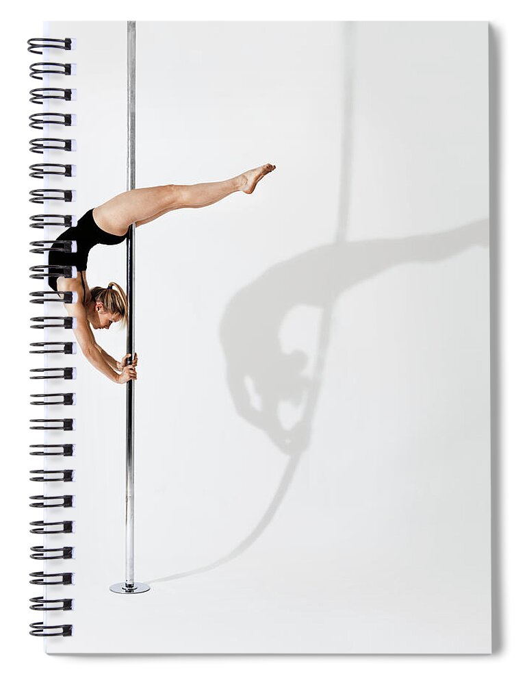 Shadow Spiral Notebook featuring the photograph Gymnast Holding Herself Up On A Pole by Henrik Sorensen