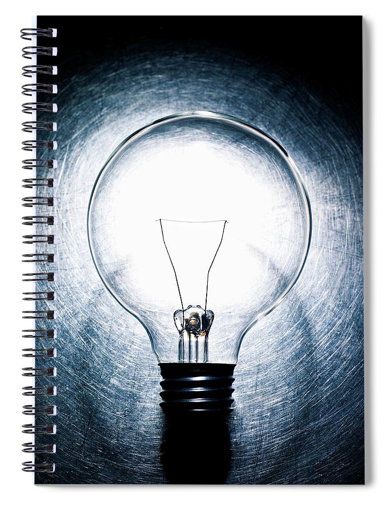 Spot Lit Spiral Notebook featuring the photograph Light Bulb On Stainless Steel by Ballyscanlon