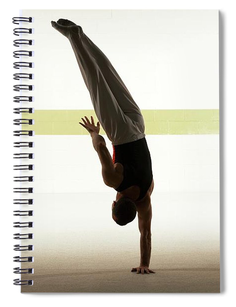People Spiral Notebook featuring the photograph Male Gymnast Balancing On One Hand On by Romilly Lockyer
