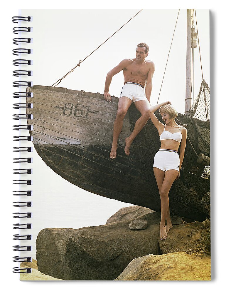 Hand Raised Spiral Notebook featuring the photograph Man Sitting Boat, Woman Standing Beside by Tom Kelley Archive
