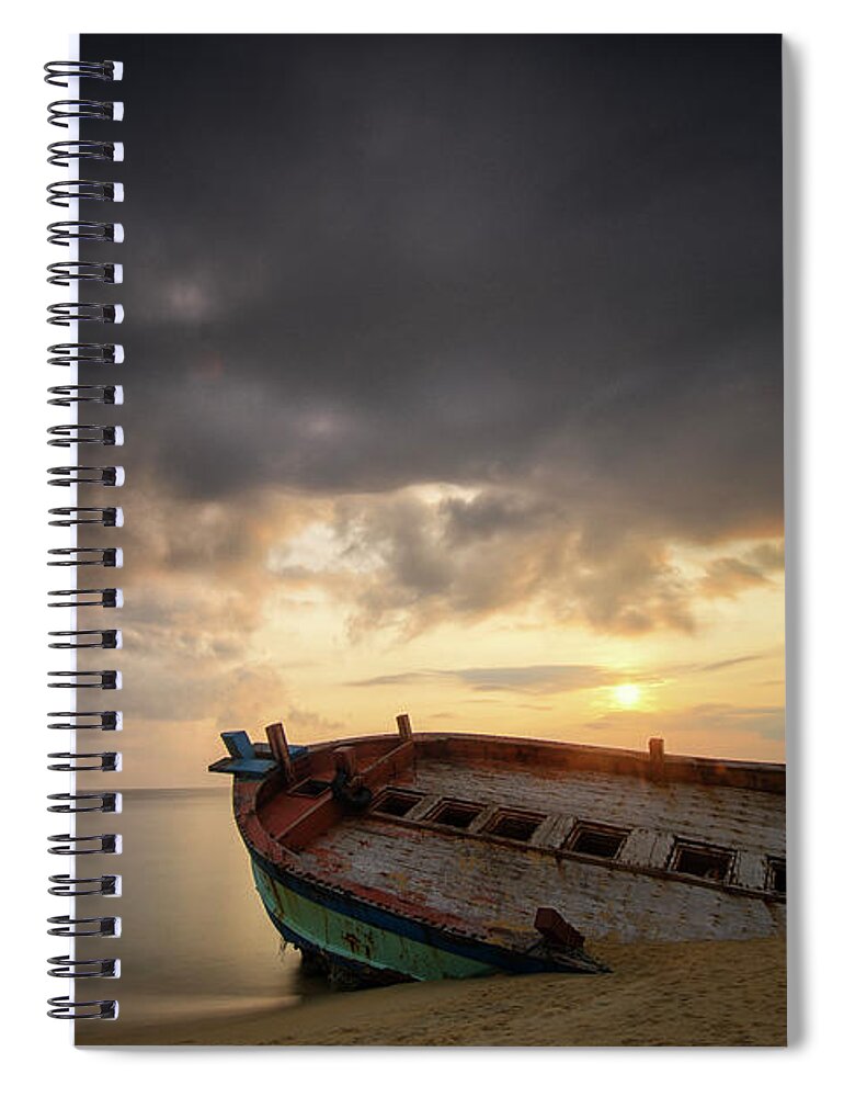 Damaged Spiral Notebook featuring the photograph Old And Broken Wooden Boat On Sandy by Yusri Salleh