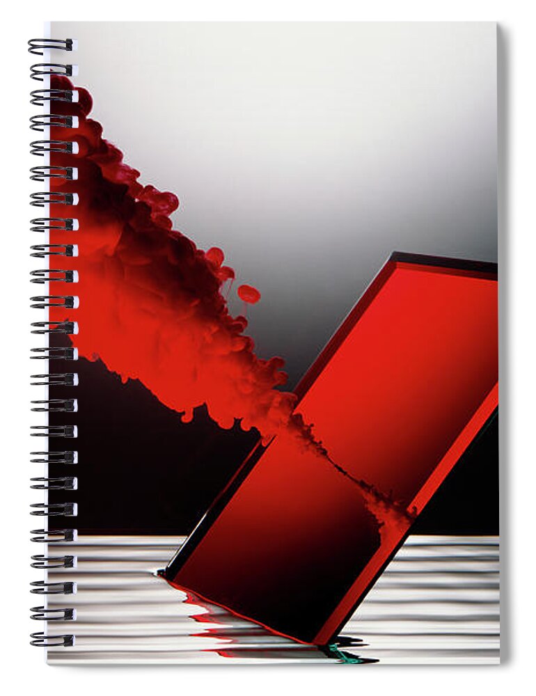 1980-1989 Spiral Notebook featuring the photograph Red Smoke Emitting From Mirror In Water by Ray Massey
