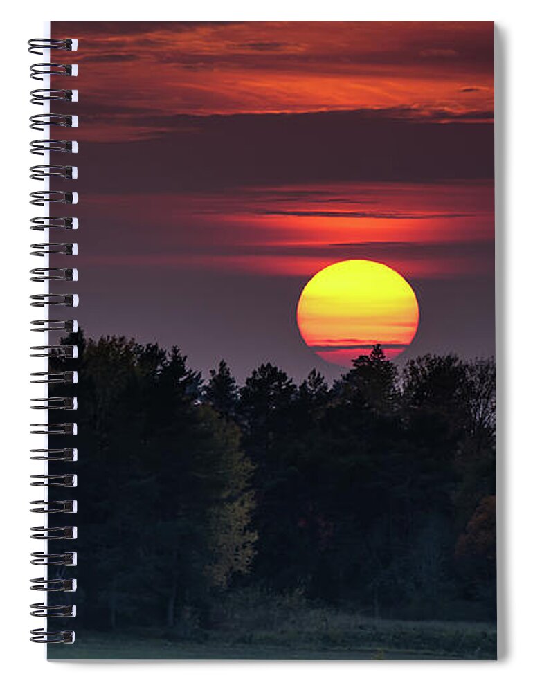 Sunset Spiral Notebook featuring the photograph Sunset at an hazy evening by Torbjorn Swenelius