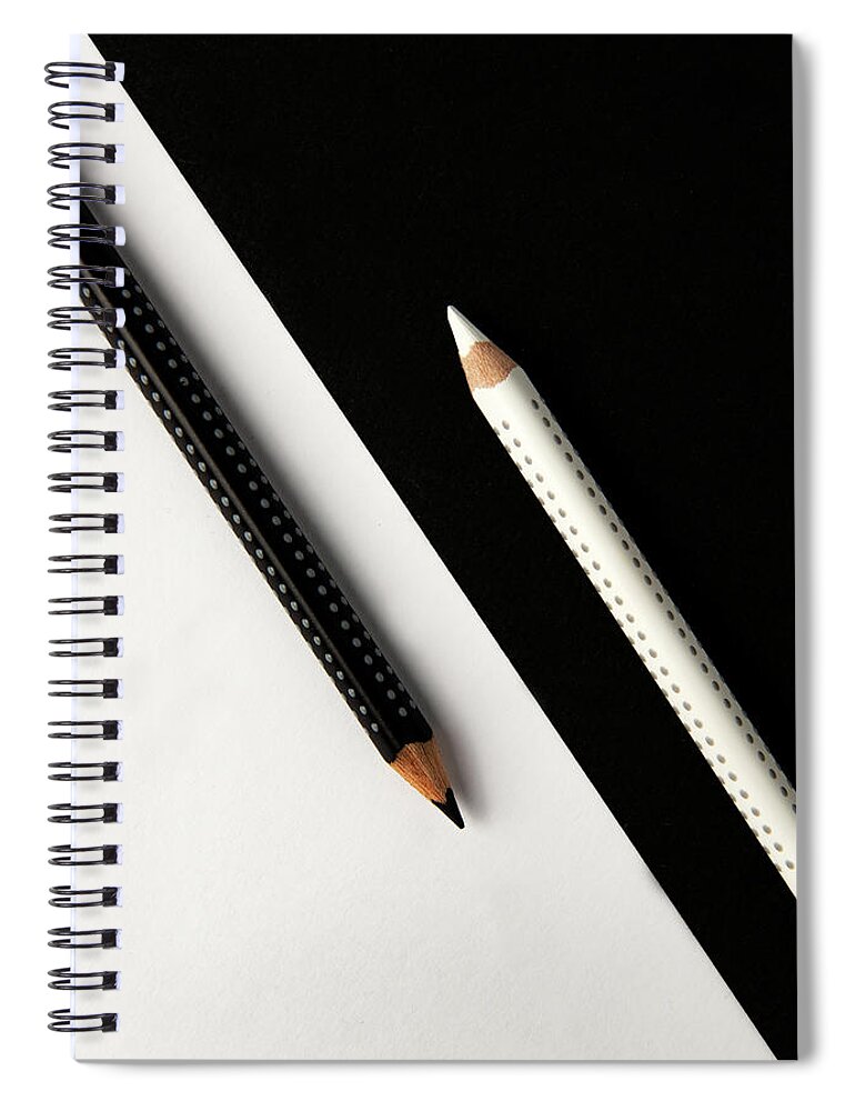 Pencil Spiral Notebook featuring the photograph Two drawing pencils on a black and white surface. by Michalakis Ppalis