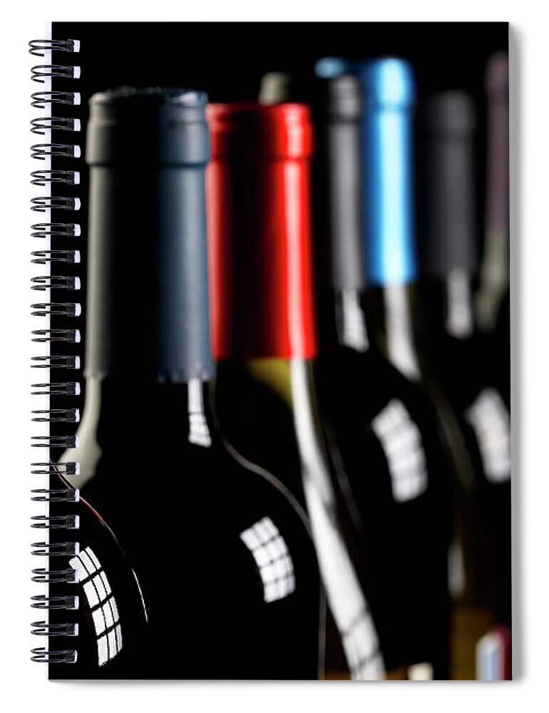 Alcohol Spiral Notebook featuring the photograph Wine Bottles In A Row On Black by Hirkophoto
