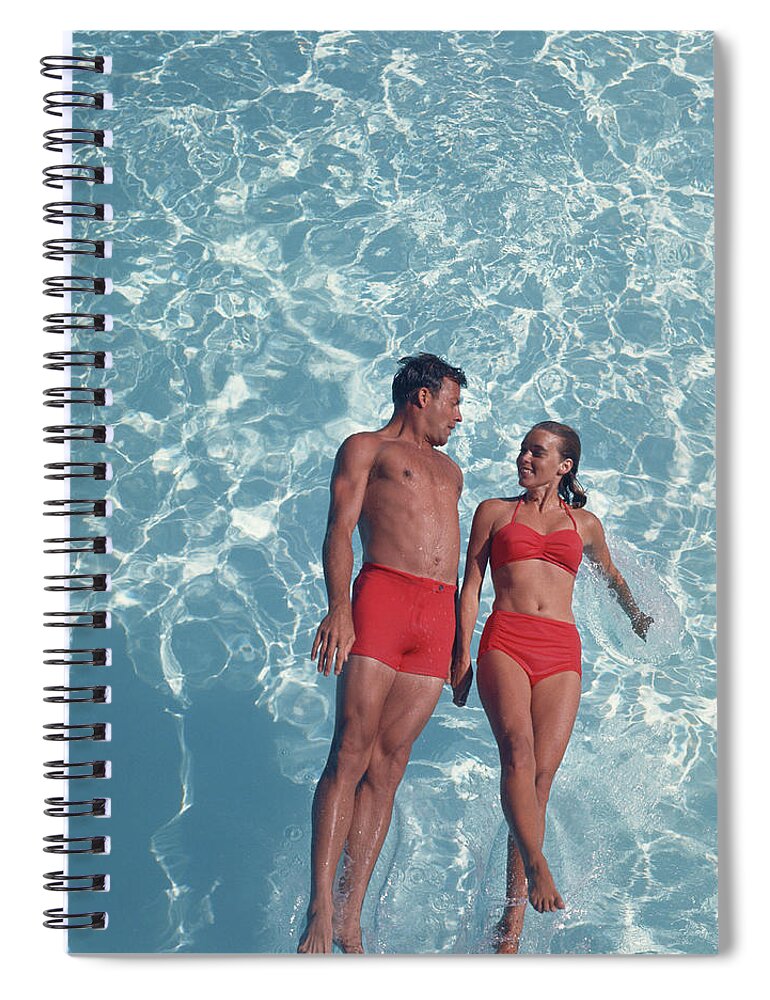Young Men Spiral Notebook featuring the photograph Young Couple Jumping In Swimming Pool by Tom Kelley Archive
