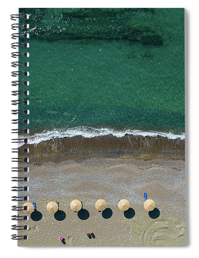 Summertime Spiral Notebook featuring the photograph Aerial view from a flying drone of beach umbrellas in a row on an empty beach with braking waves. #1 by Michalakis Ppalis