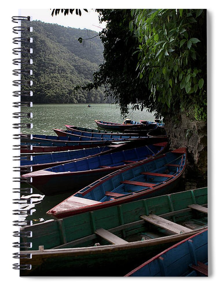 Pokhara Spiral Notebook featuring the photograph A man and boats, Pokhara by Joseph Philipson