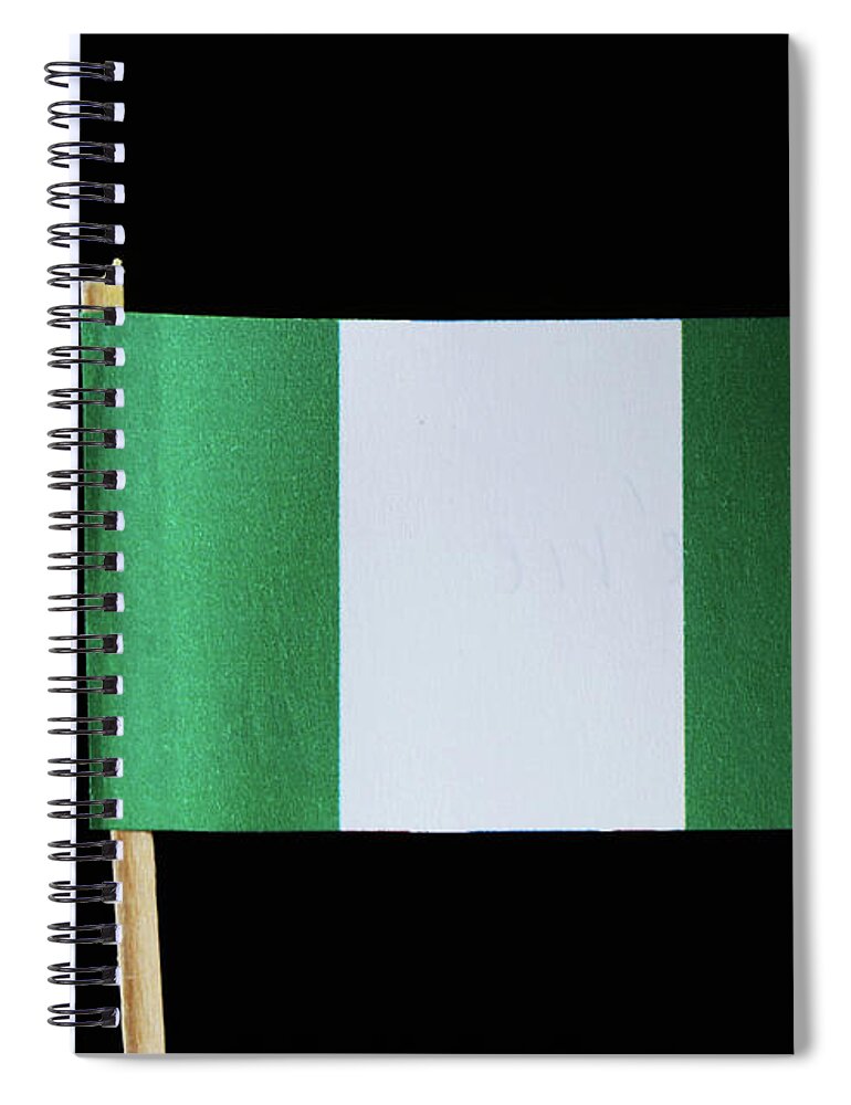Federal Republic Of Nigeria Spiral Notebook featuring the photograph A national flag of Nigeria on toothpick on black background. Nigerian flag contain green and white colour. by Vaclav Sonnek
