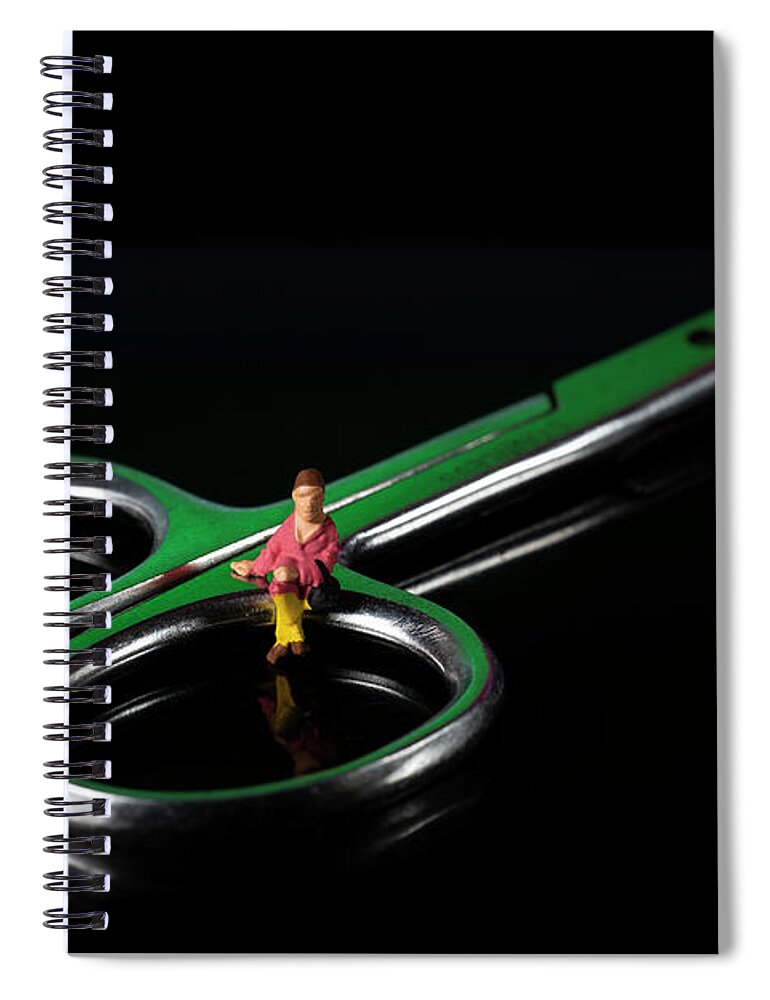 Fashionable Spiral Notebook featuring the photograph Girl sitting on nail scissors. Miniature people. Black background. Concept of health education. Macro by Pablo Avanzini