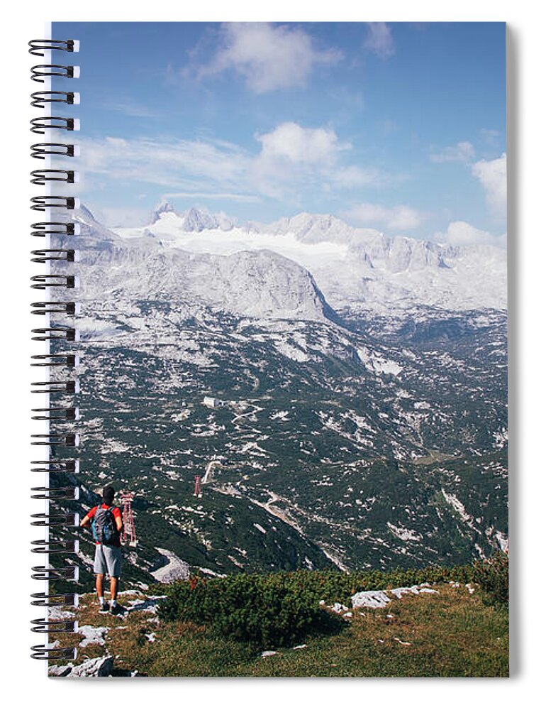 Sportive Spiral Notebook featuring the photograph Man with a backpack looks at the Dachstein massif by Vaclav Sonnek