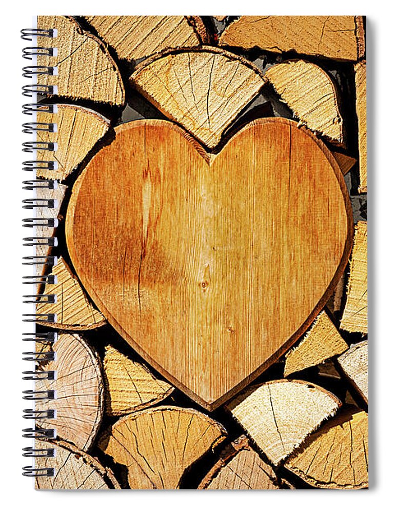 Pile Spiral Notebook featuring the photograph Stack of firewood with a wooden heart by Bernhard Schaffer