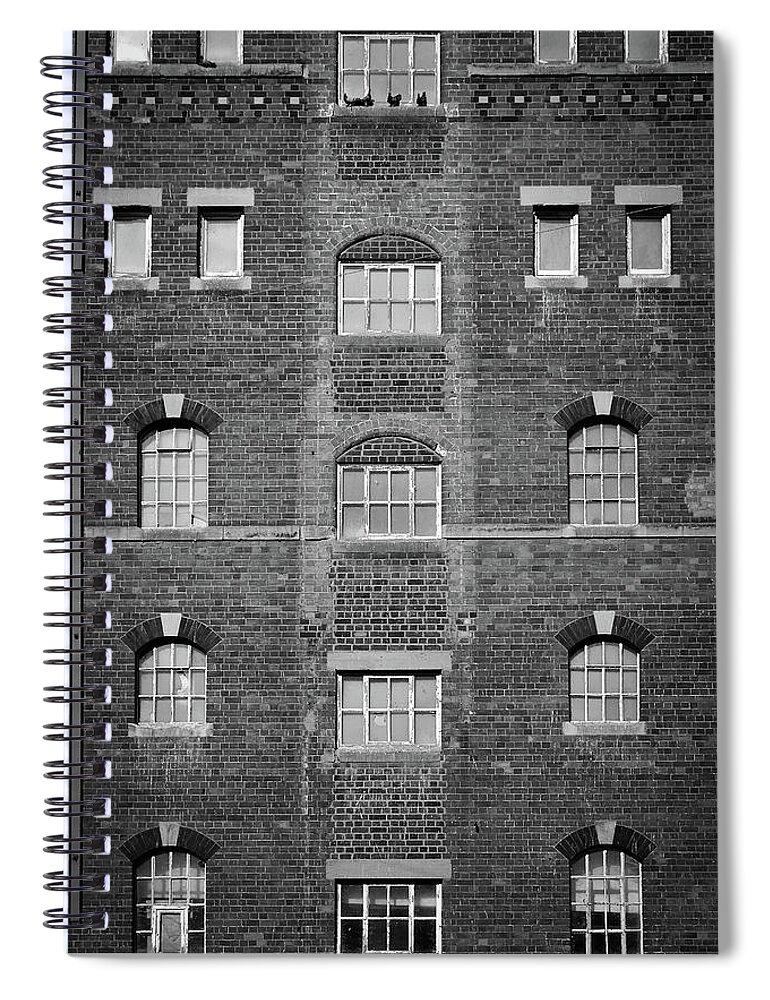 Background Spiral Notebook featuring the photograph Symmetrical Industrial building windows by Seeables Visual Arts