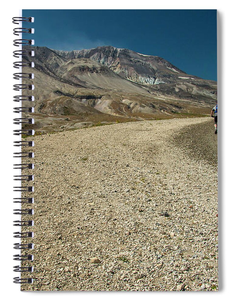 Two Bicyclists On The Windy Ridge Road Pass Directly In Front Of Mt. St. Helens' Blast Zone. Spiral Notebook featuring the photograph Take a Ride on the Wild Side by Doug Scrima