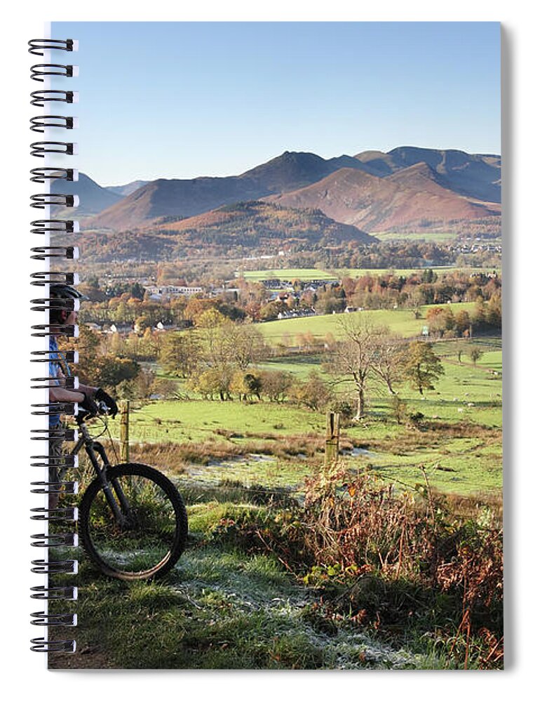 Young Spiral Notebook featuring the photograph Young couple on bikes looking over Cumbrian fells, England, UK by Bryan Attewell