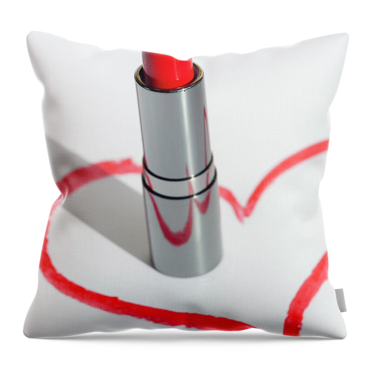 White Background Throw Pillow featuring the photograph A Lip-stick In A Drawn Heart Shape On by Reggie Casagrande