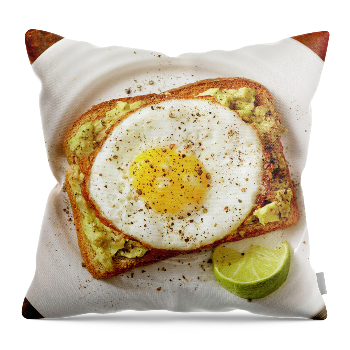 Breakfast Throw Pillow featuring the photograph Avocado Toast With A Fried Egg by Lauripatterson